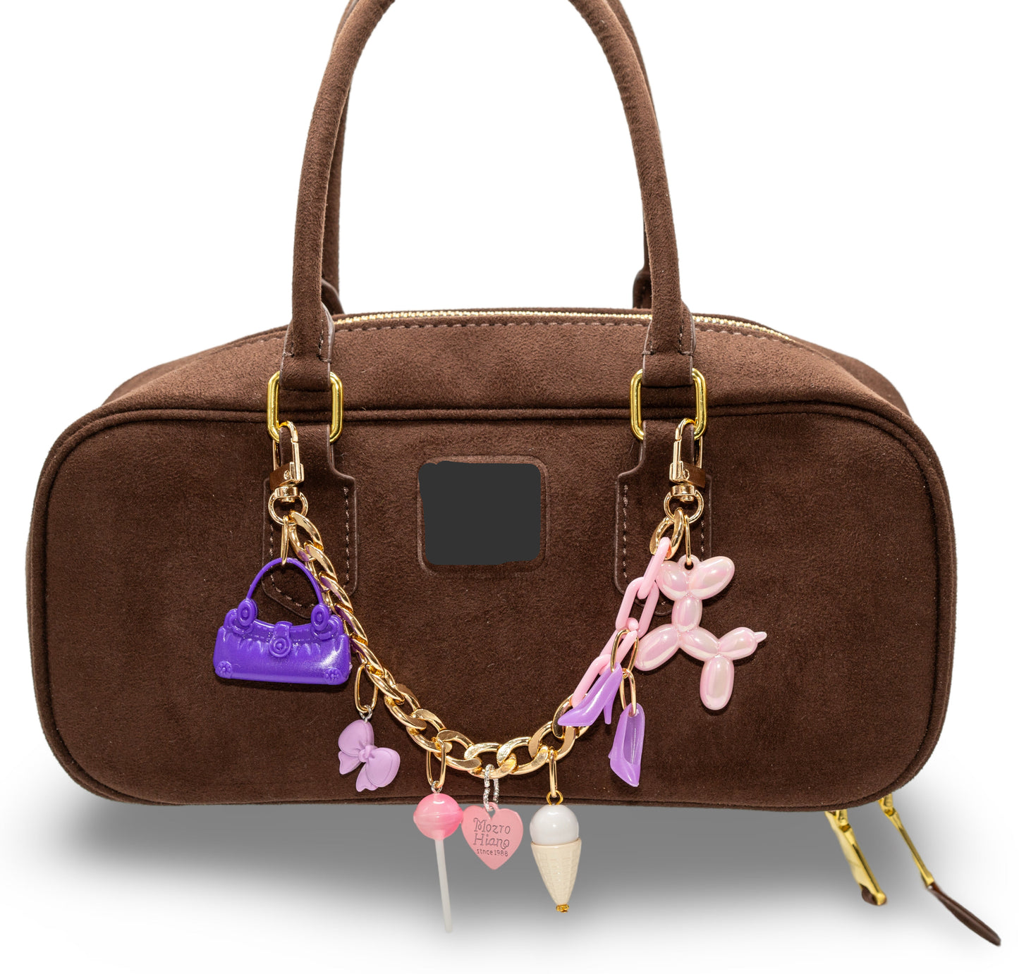 A brown handbag with custom-made chain charms attached to it. The charms include a purple heart, a pink butterfly, and other decorative elements.