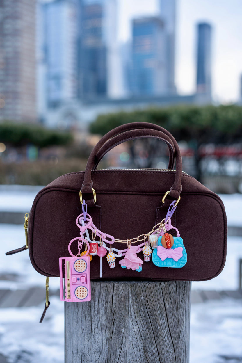 colorful charms on a wooden post against a cityscape background