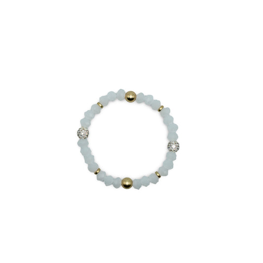 Bracelet with white beads and gold accents on a white background